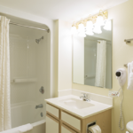 Bathroom with fixtures and vanity lighting